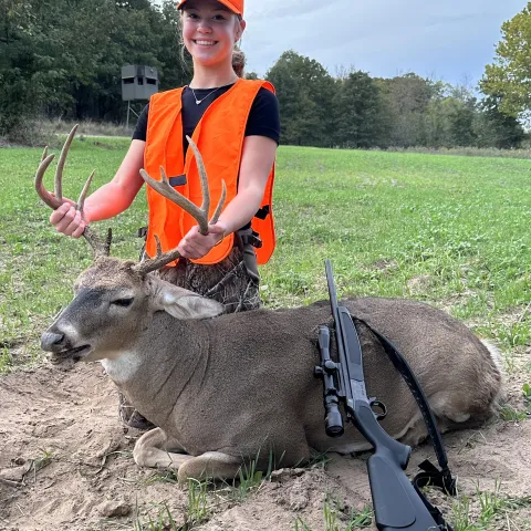 Avery May with her harvested buck from a antlered draw hunt on the Bayou Creek ranch.
