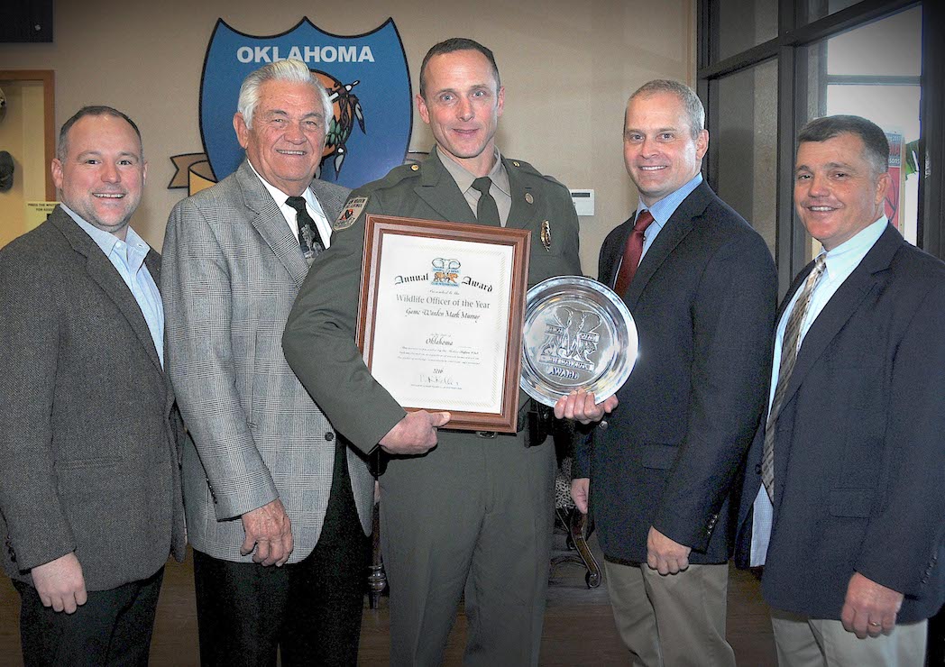 Recognizing state game warden Mark Murray, center, as 2016 Officer of the Year are, at left, Raegen Siegfried and Bill Brewster of Shikar-Safari Club International, and at right, Lt. Col. Nathan Erdman, assistant chief of law enforcement, and Col. Bill Hale, chief of law enforcement with the Oklahoma Department of Wildlife Conservation. Not pictured: Suzie Brewster of Shikar-Safari Club International.   (DON P. BROWN / ODWC)