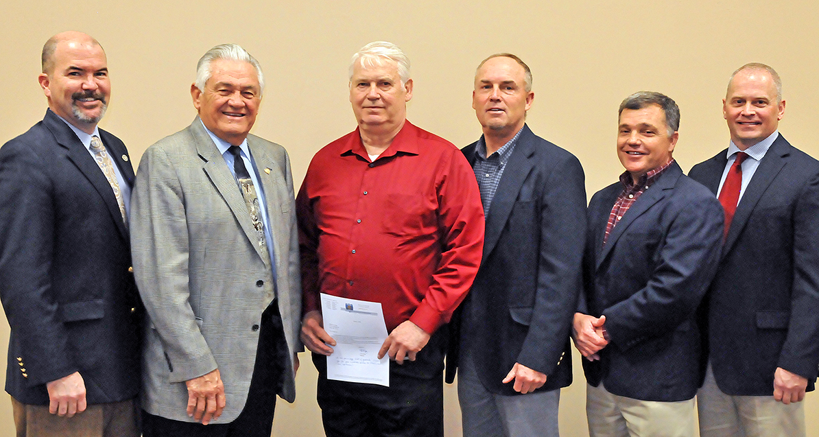 Gathered to honor the longest-tenured Oklahoma Game Warden for 45 years of service are, from left, J.D. Strong, Wildlife Department Director; Wildlife Commissioner Bill Brewster; honoree Game Warden Lt. Arthur Joe Young; Wade Free, Department Assistant Director; Bill Hale, Law Enforcement Chief; and Nathan Erdman, Law Enforcement Assistant Chief. (Photo by Don P. Brown/ODWC)