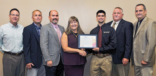 Presenting the National Bobwhite Conservation Initiative's 2017 Fire Bird Conservation Award for Oklahoma are, from left, James Dietsch of Central Oklahoma 89er Chapter of Quail Forever; Wildlife Department Assistant Director Wade Free; Department Director J.D. Strong; honoree Laura McIver, regional representative, Oklahoma and Texas Quail Forever; Derek Wiley, Department upland game biologist; Wildlife Division Chief Alan Peoples; and Wildlife Division Assistant Chief Bill Dinkines. (Don P. Brown/ODWC)