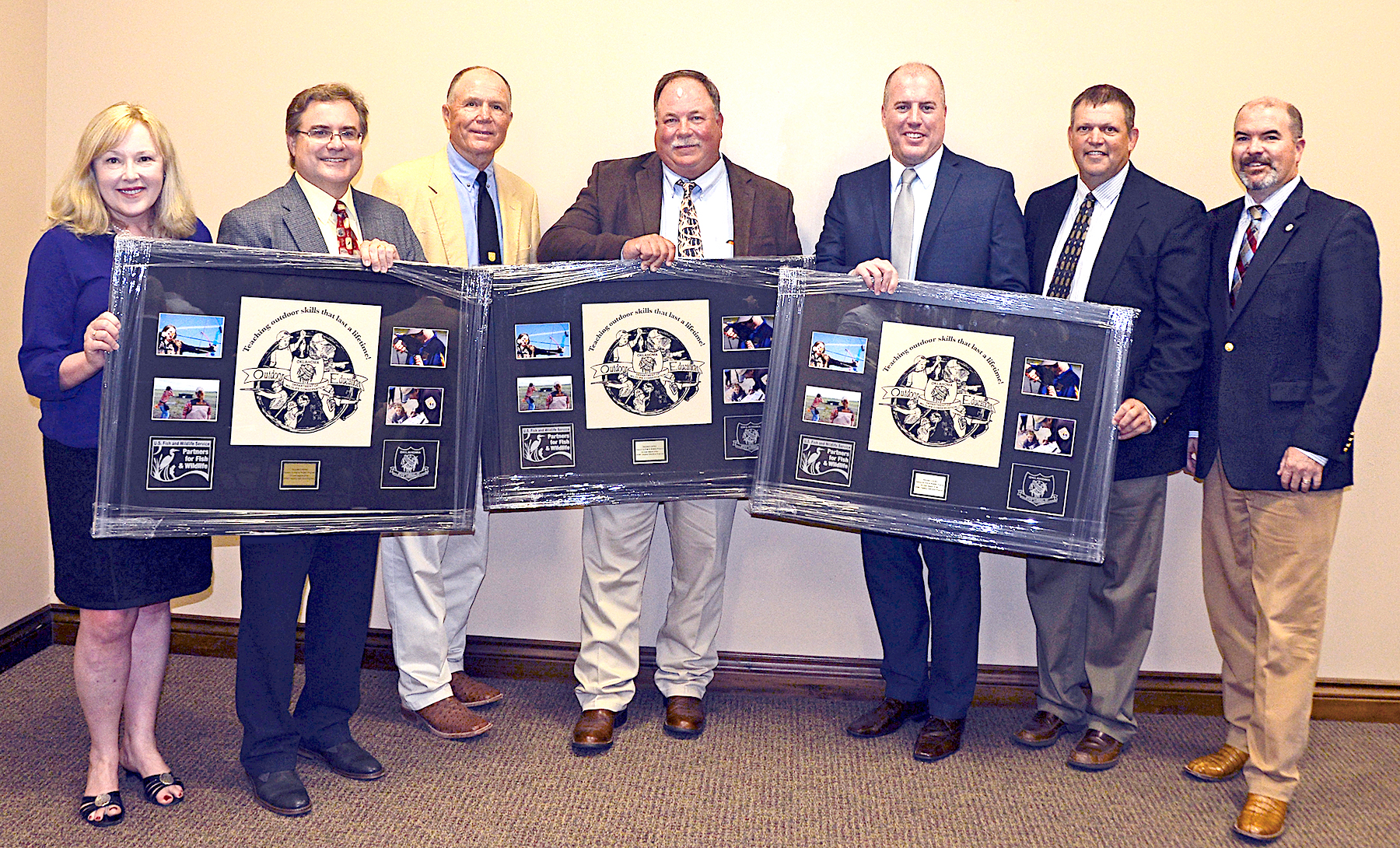 Partners for Fish and Wildlife Program of the U.S. Fish and Wildlife Service was recognized for supporting Outdoor Education. From left are Jonna Polk, Don Wilhelm, Terry Dupree, John Hendrix, Matt Filsinger, ODWC Education Supervisor Colin Berg, and ODWC Director J.D. Strong. (Don P. Brown/ODWC)