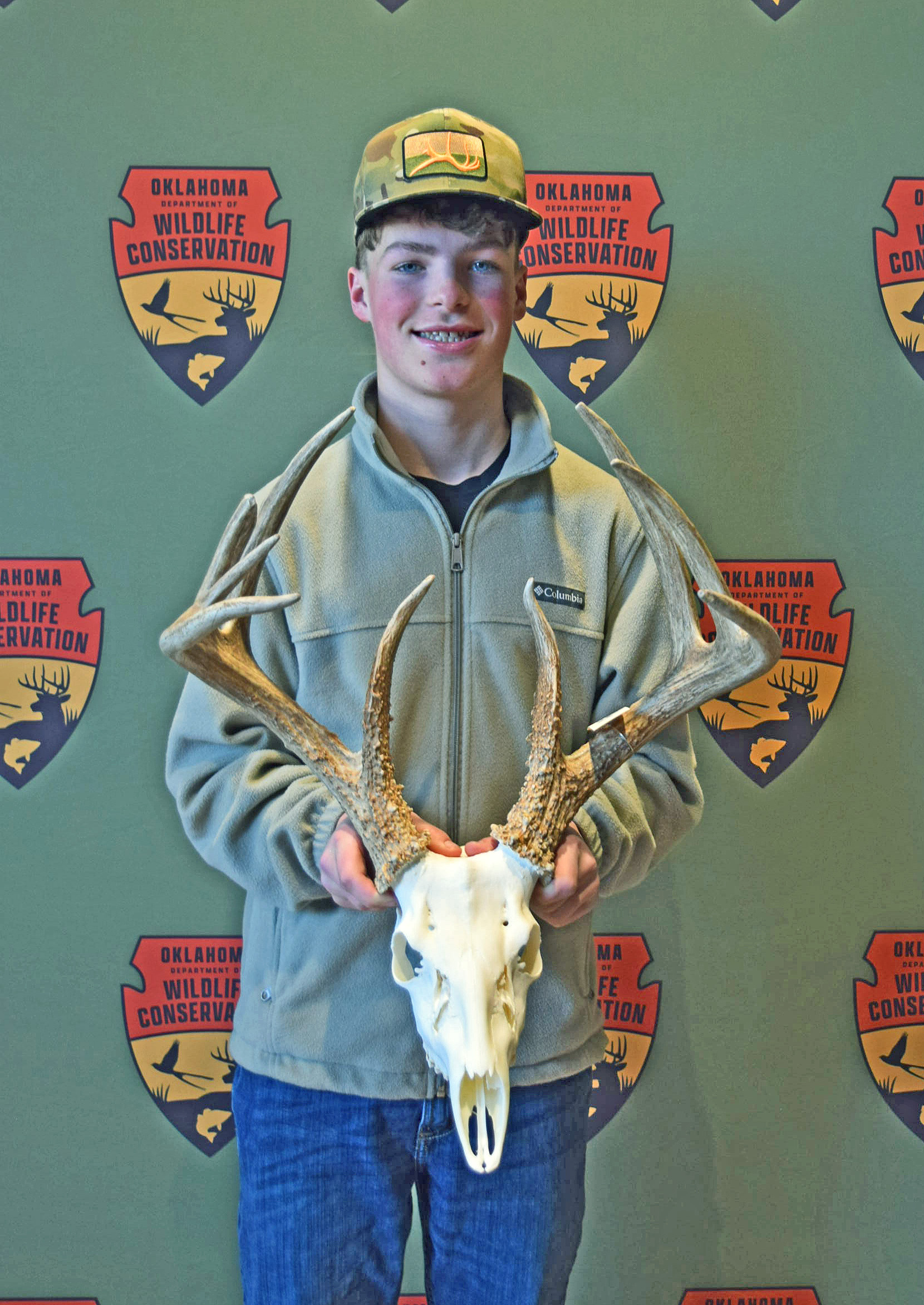 hunter bishop holding a deer rack