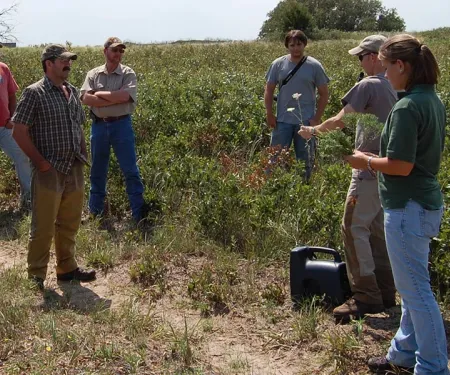 Biologist in the field with landowners.