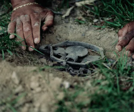 A photo of hands setting a trap.