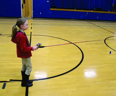 A girl casting a fishing rod. 