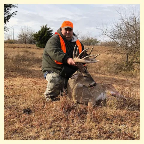 Louise Nottingham in field with harvested buck.