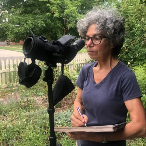 Woman looking through scope.