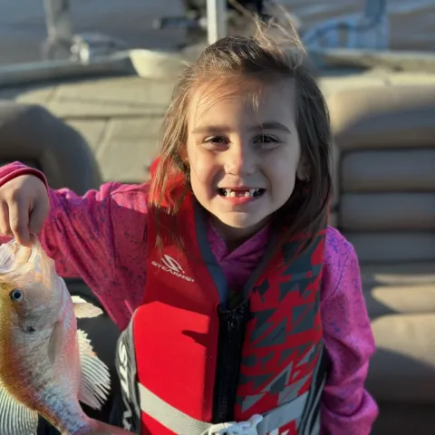 Mia West holding a crappie
