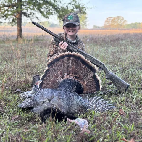 Faith Rowan with her harvested Oklahoma wild turkey