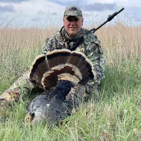Glendal French with his harvested Oklahoma wild turkey