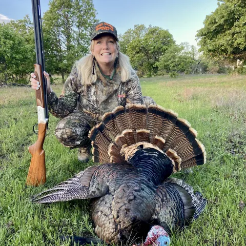 Jennifer Rupe with her harvested Oklahoma wild turkey