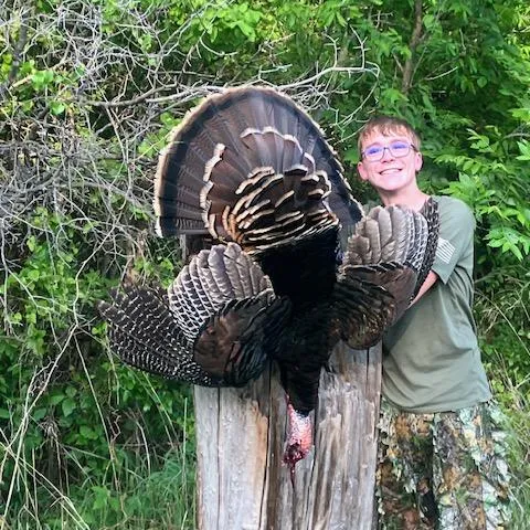 Zachary Watkins with his harvested Oklahoma Wild Turkey