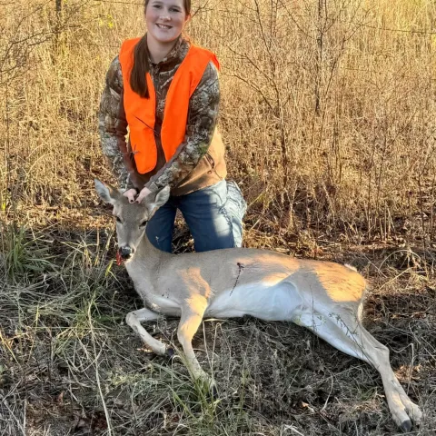 Ryleigh McAlister with her harvested Oklahoma White-tailed deer.