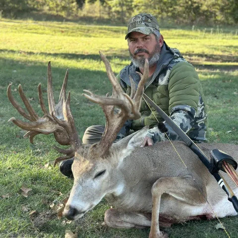 Hunter pictured with non-typical deer harvested with longbow.