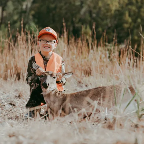 Antlerless deer pictured with young hunter.