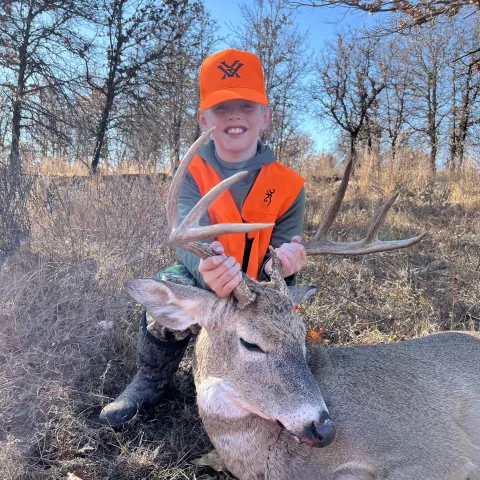 Youth hunter with deer.