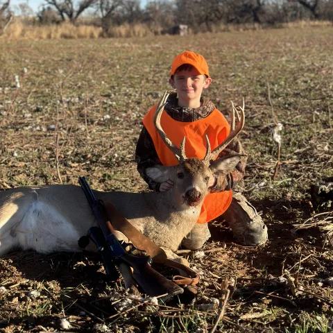 Youth hunter with deer.