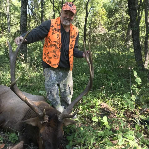 Hunter with harvested elk.