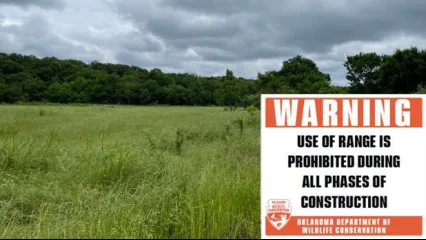 A photo of a field at Atoka WMA where a new ODWC shooting range will be built. There is a warning on the image that reads, "Warning. Use of range is prohibited during all phases of construction - Oklahoma Department of Wildlife Conservation."