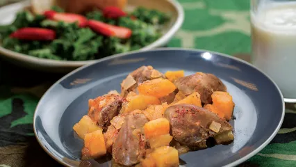 A plate of baked dove breasts smothered in apples and vegetables