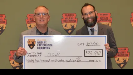 Wade Free and Sean McCabe pose with a large check
