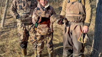 two men and a boy duck hunting