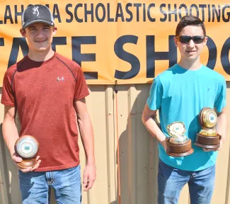 Top junior male shooters are Jacob Diller of Timberlake, runner-up; and Kaehl Smith of Wesleyan Christian School, champion junior male and top overall junior shooter. Not pictured: Teddy Bowels of Colbert, second runner-up.