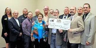 NWTF members and ODWC staff stand together with donation check.