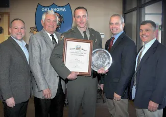 Recognizing state game warden Mark Murray, center, as 2016 Officer of the Year are, at left, Raegen Siegfried and Bill Brewster of Shikar-Safari Club International, and at right, Lt. Col. Nathan Erdman, assistant chief of law enforcement, and Col. Bill Hale, chief of law enforcement with the Oklahoma Department of Wildlife Conservation. Not pictured: Suzie Brewster of Shikar-Safari Club International.   (DON P. BROWN / ODWC)