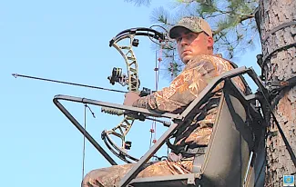 Gov. Kevin Stitt bowhunting in a tree stand