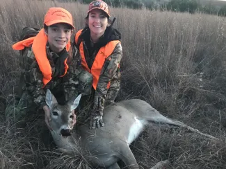 Mother with sun in the field with harvested doe.
