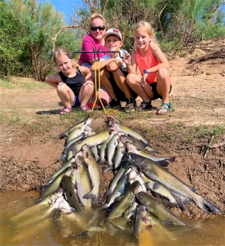 A family with two stringers of catfish
