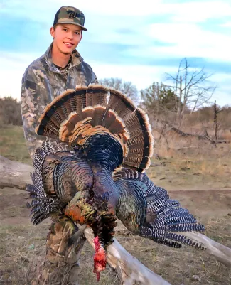 Youth with harvested turkey.