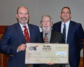 NWTF Oklahoma President O.D. Curry, center, presents a $53,881 donation to Wildlife Department Director J.D. Strong and Assistant Chief of Wildlife Bill Dinkines. (Don P. Brown/ODWC)