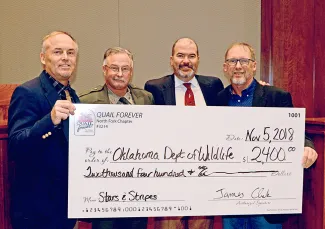 Accepting a $2,400 donation for the Stars and Stripes Project from North Fork Quail Forever Chapter President Jimmy Clark, right, are Wildlife Department Assistant Director Wade Free, Game Warden and QF member Lt. Jeff Headrick, and Director J.D. Strong. (Don P. Brown/ODWC)