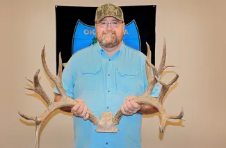Ron Jones of Pryor holds the new Oklahoma Cy Curtis record mule deer rack, which scores 226 4/8. The rack crushed the previous record muley, which was harvested in 1973.   (SKYLAR ST.YVES / ODWC)