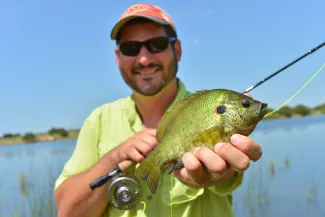 Man holding a redear sunfish.