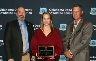 Gathered for presentation of the Mark J. Reeff Memorial Award from the Association of Fish and Wildlife Agencies are, from left, ODWC Director J.D. Strong, Communication Supervisor Kelly Adams (honoree), and Communication and Education Chief Nels Rodefeld. (Don P. Brown/ODWC)