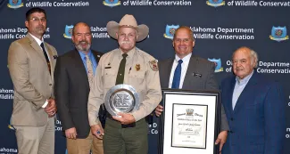 Gathered for presentation of the Shikar-Safari Club International 2021 Wildlife Officer of the Year Award are, from left, Assistant Chief Wade Farrar, ODWC Director J.D. Strong, honoree Game Warden Kenny Lawson, Law Enforcement Chief Nathan Erdman, and Shikar-Safari member Robin Siegfried. (Don P. Brown/ODWC)