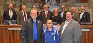 Members of the Oklahoma Wildlife Conservation Commission and ODWC Director J.D. Strong (back row) stand to recognize Northmoor Elementary archery coach Ed Fowlks, national third-place archer Ethan Do, and ODWC Archery in the Schools Coordinator Kelly Boyer. (Don P. Brown/ODWC)