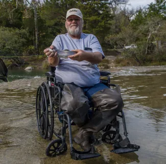 Man in wheelchair at Blue River.