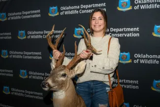 rack madness attendee poses with antlers
