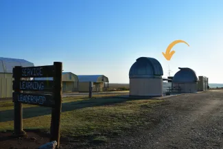 A yellow arrow points to a Motus tower installed at the Selman Living Laboratory.