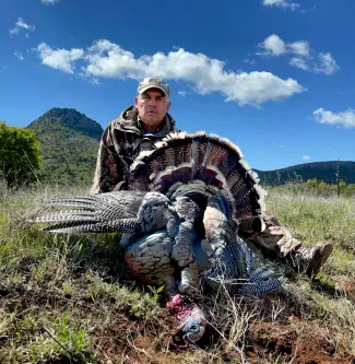 A photo of Wade Free with a harvested turkey.