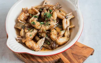 A bowl of fried frog legs.