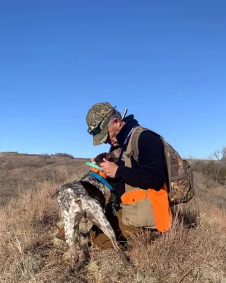 man petting gsp dog