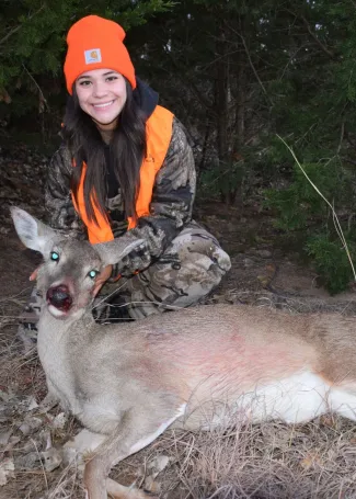 girl with a harvested doe