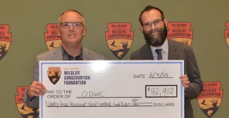 Wade Free and Sean McCabe pose with a large check