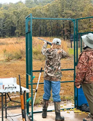 A hunting youth is being instructed on how to safely use a shotgun at an ODWC field day event.