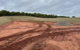 An update photo of the Lexington WMA shooting range, showing berms with new grass.